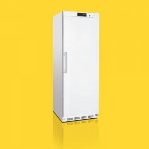 A white, single-door refrigerator stands upright on a reflective surface, set against a bright yellow background.