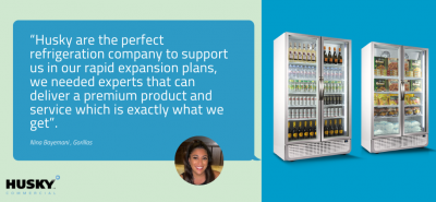 Testimonial text praising Husky refrigeration, attributed to Nina Baynesova from Gorillas, with her image. On the right, two commercial display refrigerators filled with drinks and food on a blue background. Text: "Husky are the perfect refrigeration company to support us in our rapid expansion plans, we needed experts that can deliver a premium product and service which is exactly what we get".
