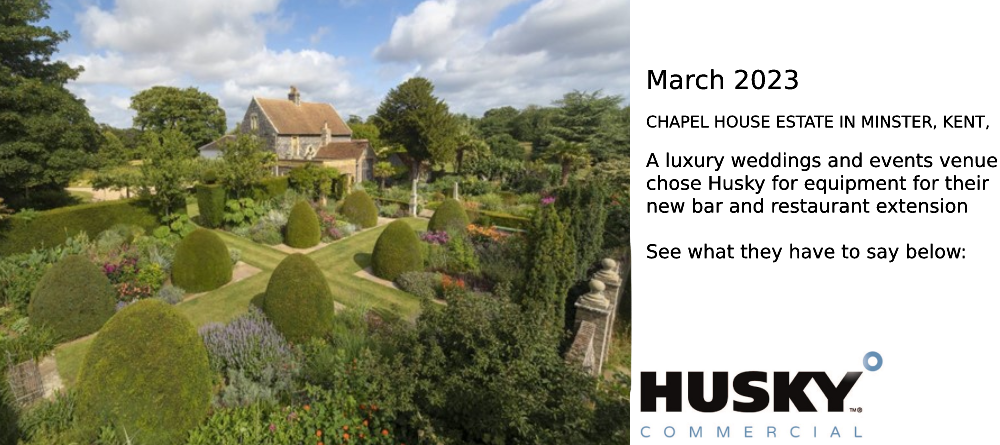 A quaint cottage surrounded by a meticulously landscaped garden with neatly trimmed topiary bushes and vibrant flowerbeds; lush greenery and tall trees provide a serene backdrop. Text: "HUSKY COMMERCIAL" in the bottom right corner.