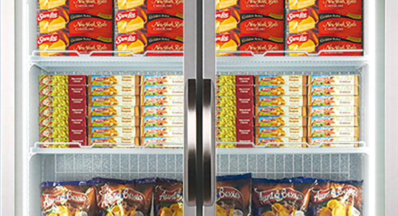Frozen food items are displayed inside a commercial refrigerator with two glass doors; several shelves are stocked with pizzas, potato chips, and other packaged goods. Brands visible include "Ristorante," "McCain," "Aunt Bessie's," and "Birds Eye."