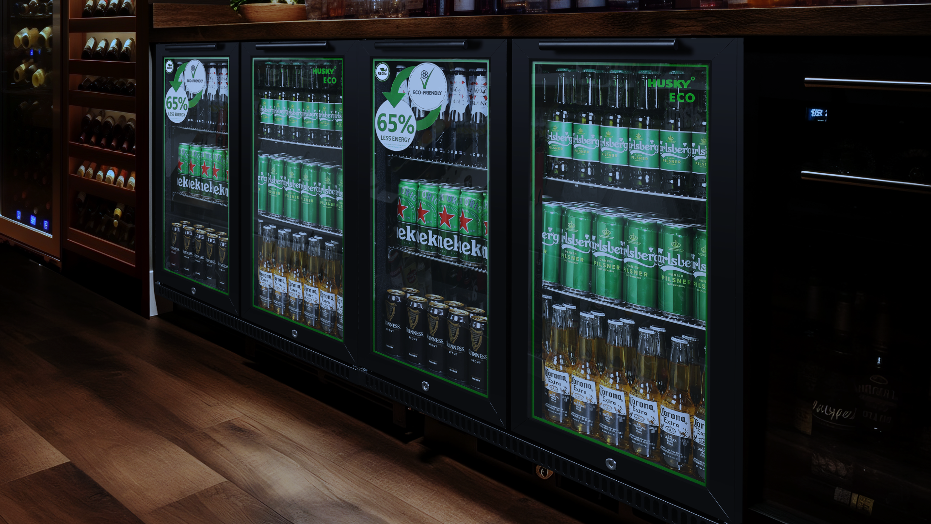 A sleek Husky Eco back bar fridge with glass doors, stocked with beer and beverages, featuring an energy-saving 65% less energy label. Ideal for bars and pubs looking for eco-friendly refrigeration solutions.