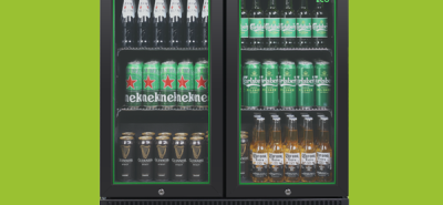 A double-door refrigerator, labeled "Husky ECO", displays beer bottles on the top shelf, beer cans on the middle shelf, and bottles of beer and cans of beer on the bottom shelf, against a green background.