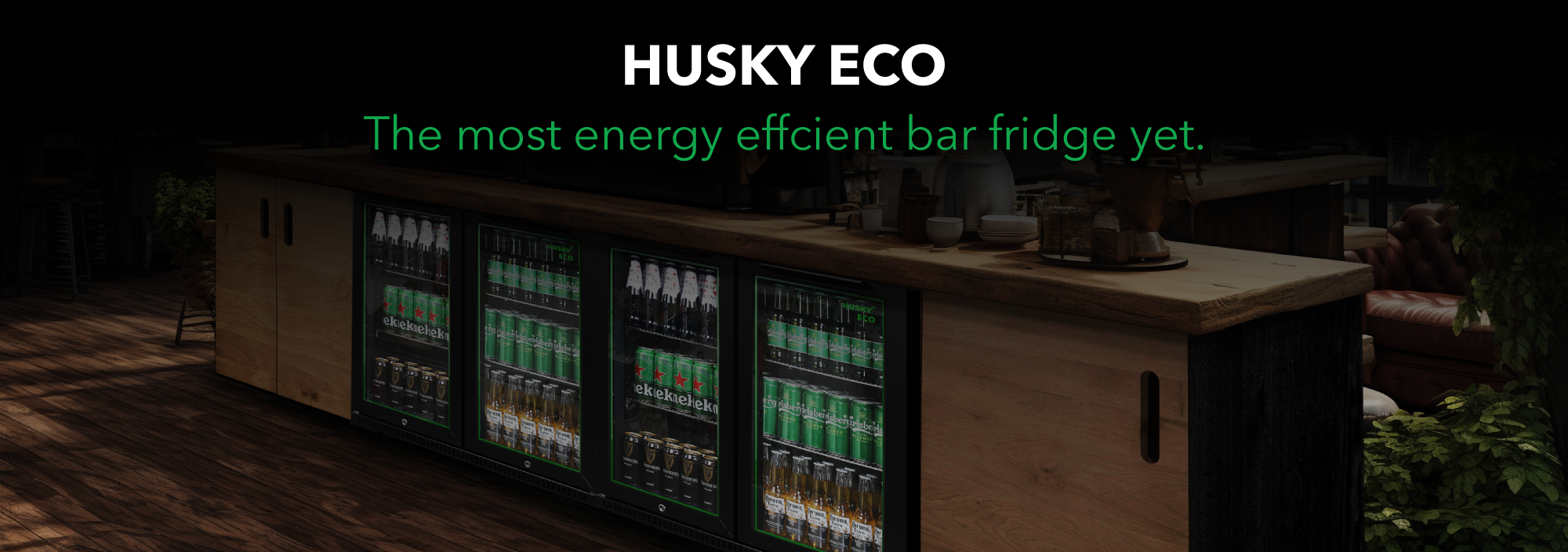 A stylish wooden bar setup featuring three Husky ECO back bar fridges filled with drinks, accompanied by the headline “HUSKY ECO – The most energy efficient bar fridge yet.”