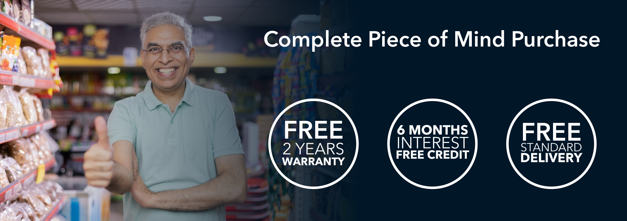 A happy shop owner standing in a grocery aisle giving a thumbs up, next to a promotional banner from Husky Refrigerators highlighting “Complete Piece of Mind Purchase” with icons stating Free 2 Years Warranty, 6 Months Interest-Free Credit, and Free Standard Delivery.